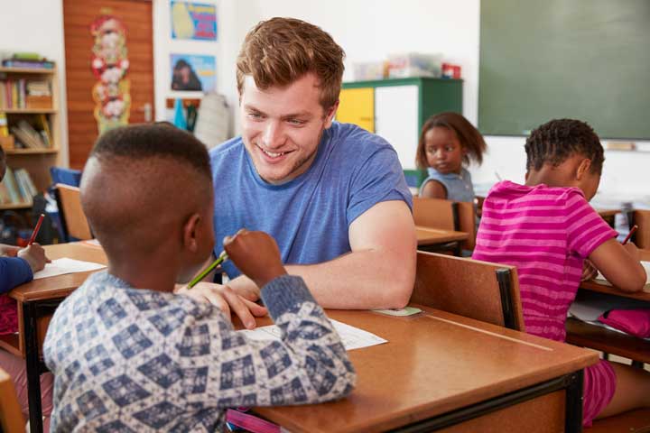 teacher helps individual student